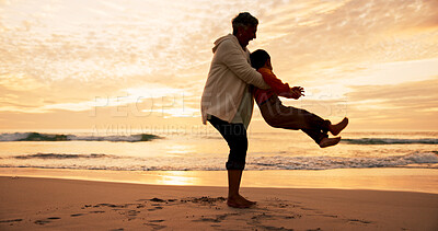 Buy stock photo Mother, son and lifting on beach at sunset for family bonding, travel for wellness and playful fun. Mom, boy child and together by ocean with sand on vacation, adventure or freedom in Indonesia