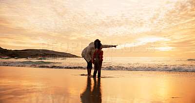 Buy stock photo Mom, son and pointing on beach at sunset for family bonding, travel for wellness with view. Mother, boy child and together by ocean with sand on vacation for adventure or freedom in Indonesia