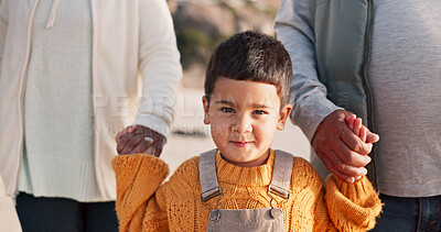 Buy stock photo Boy, child and holding hands in portrait at beach with family, outdoor and vacation with walk in nature. Kid, face and together with people, care and connection in morning for holiday in Indonesia