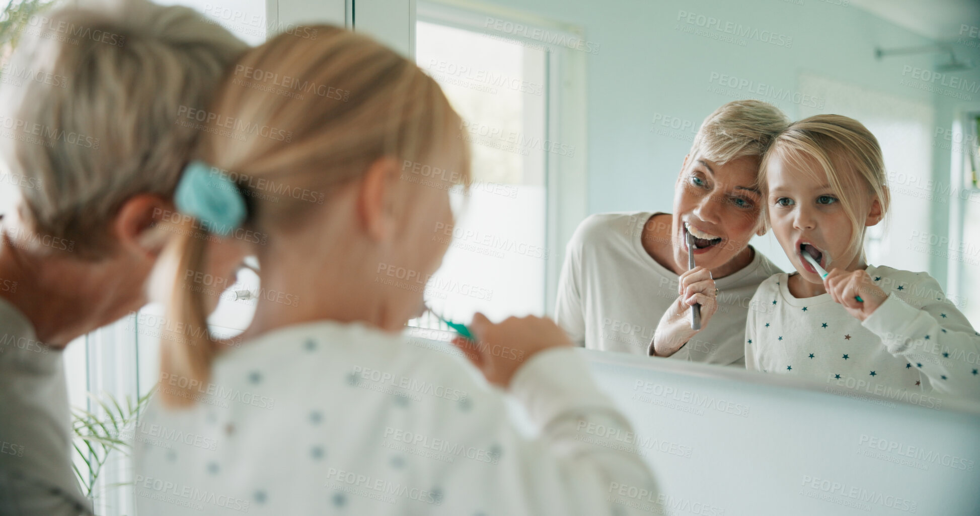 Buy stock photo Happy grandmother, kid and brushing teeth on mirror in bathroom for learning oral hygiene. Child, grandma and reflection of girl with toothbrush for cleaning, dental care and health in family home