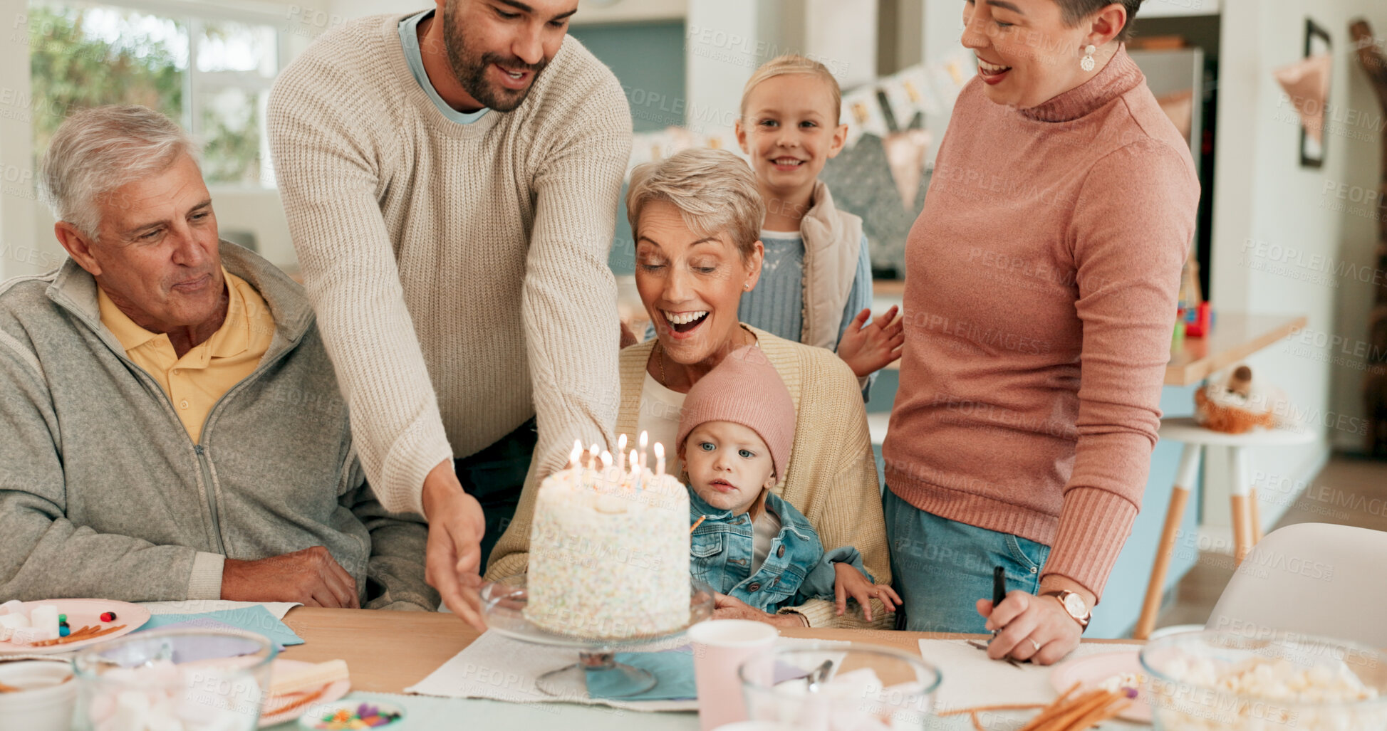 Buy stock photo Birthday, celebration and family with cake for grandmother in home with support, love and care. Happy, excited and people with dessert and candles for senior woman at party with surprise at house.