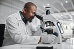 Medical, scientist and black man with microscope in lab for research, development and stem cell test. Mature person, science and biotech with review for dna, investigation and growth in vaccine study