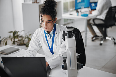 Buy stock photo Laptop, microscope and science with woman in laboratory for medical or pharmaceutical research. Computer, innovation and study with scientist at work for analysis, development or experiment results