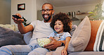 Dad, boy and happy with television or popcorn on sofa in living room for movies, cartoon and entertainment. People, parent and smile with kid on couch for streaming platform with child development