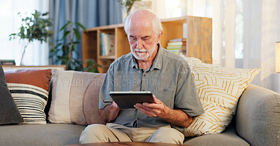 Buy stock photo Senior man, tablet and typing on sofa for web surfing with retirement, memory game or connection in home. Elderly person, tech and relax with reading ebook, online puzzle or internet scroll in lounge