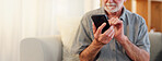 Hands, phone and space with senior man on sofa in living room of retirement home for communication. Connection, mobile and internet with elderly person checking app for bank, health or pension