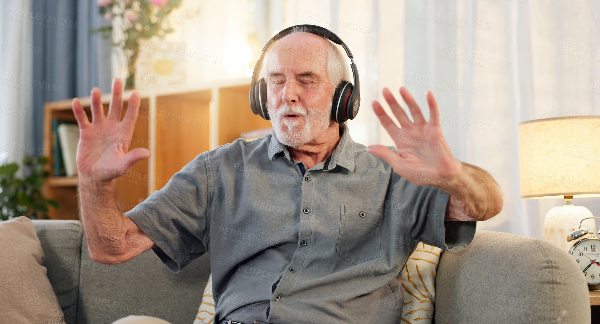 Buy stock photo Old man, headphones and dancing in home, music and having fun in retirement or streaming sound. Elderly male person, playlist and living room hip hop for audio therapy, freedom and listening on sofa