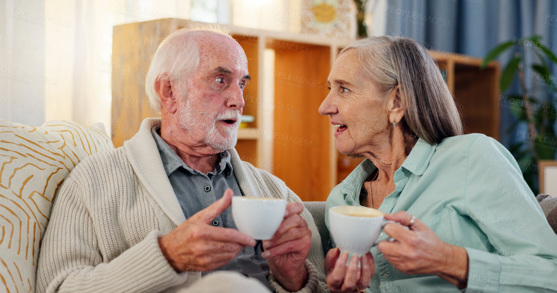 Buy stock photo Senior couple, home and coffee with chat for retirement or happiness, relax with tea for bonding. Elderly man, woman and talking together in house with espresso for wellness, gossip or wow with drink