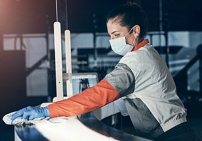 Buy stock photo Shot of a young woman cleaning the reception desk in a gym