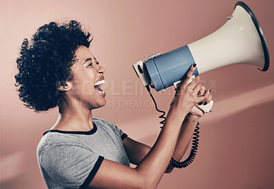 Buy stock photo Studio shot of a woman talking over a megaphone