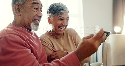 Buy stock photo Laugh, phone and senior couple in home together for funny joke, meme or reading comedy story. Retirement, man and woman on mobile in lounge for news, streaming video and relax for connection on email