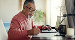 Senior man, laptop and writing at home for budget, planning and savings account for personal debt. Elderly person, computer and notebook in living room for finance, tax or loan payment on banking app