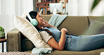 Woman, home and eyes closed with headphones on sofa for music, playlist and entertainment. Female person, couch and smile in living room for audio or radio and streaming podcast for fun and relax