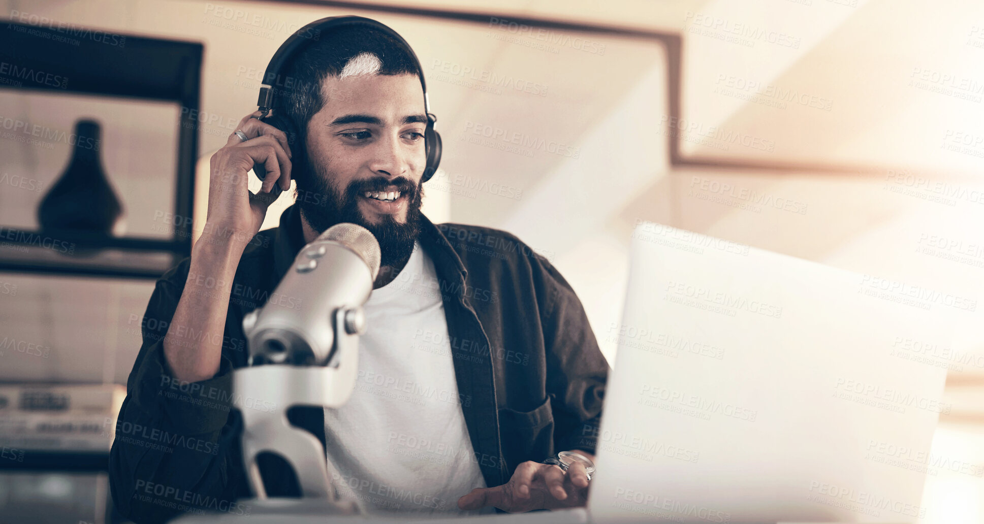 Buy stock photo Podcast, home and man with laptop, microphone and radio host with communication in lounge. Person, headphones and guy with pc, podcaster and live stream with equipment, speaking and online talk show