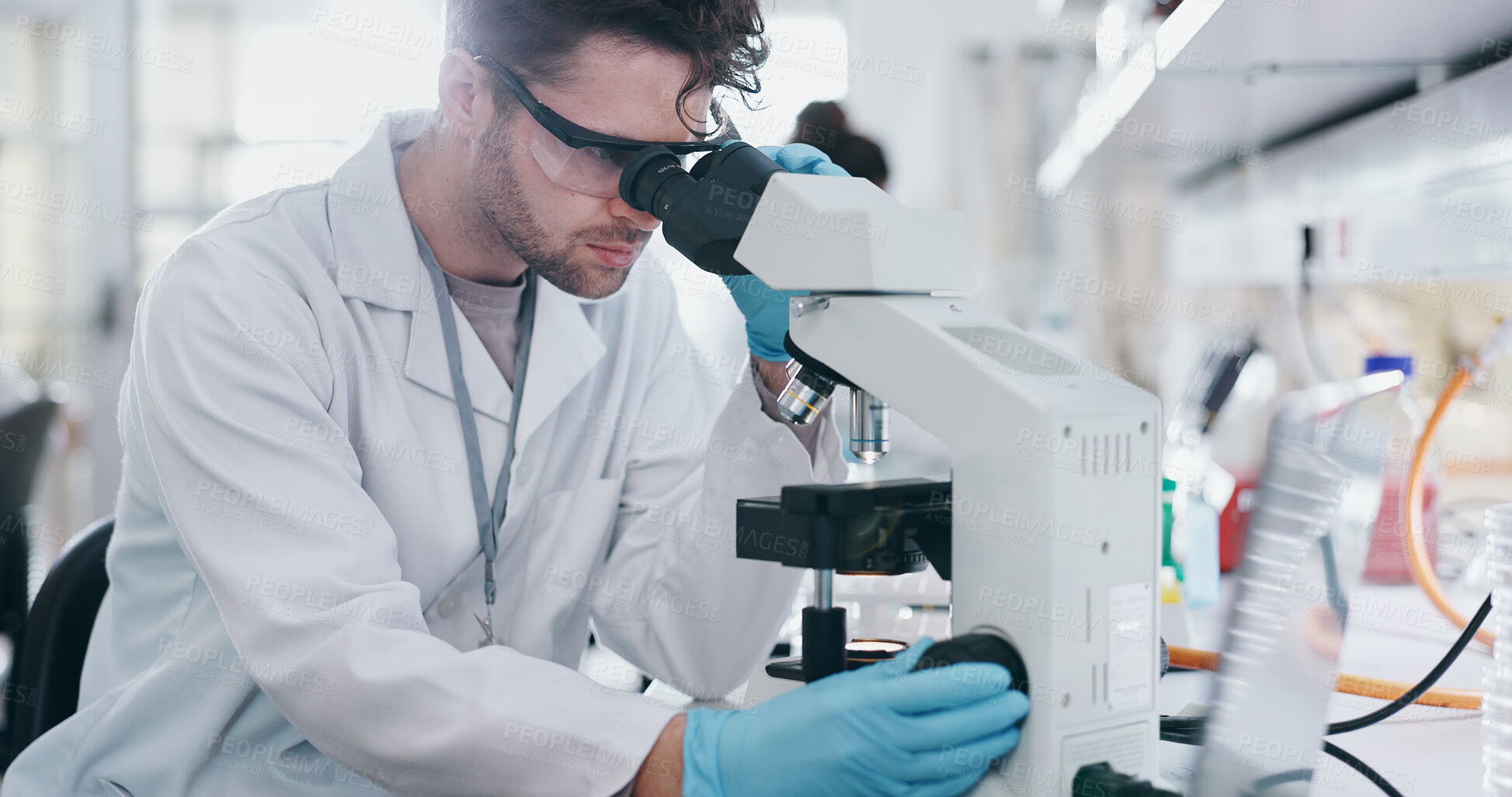 Buy stock photo Test, research and man with microscope, science and check experiment for cancer treatment. Person, scientist and employee with lab equipment, biotech and cure development with sample and studying