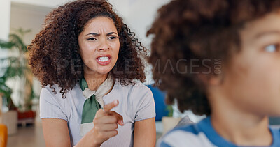 Buy stock photo Mother, shouting and boy in lounge, angry and discipline of child with disrespect in house. Scolding, kid and upset in living room of home, pointing and talk for conflict with mom, youth and parent