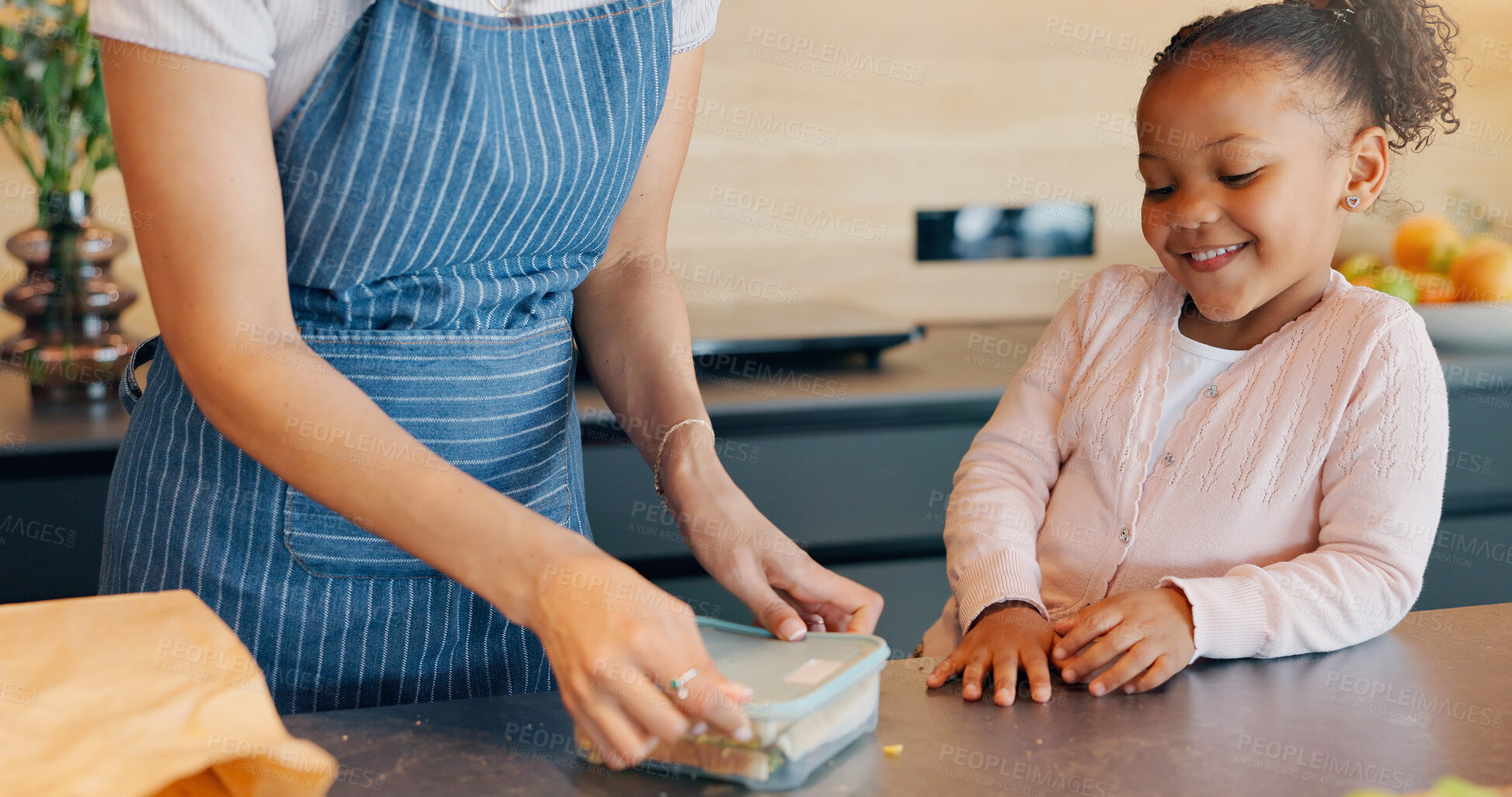 Buy stock photo Lunch box, girl and parent in kitchen with child for care, nutrition or meal prep of school or education. African kid smile for food and sandwich with family support in development or growth at home