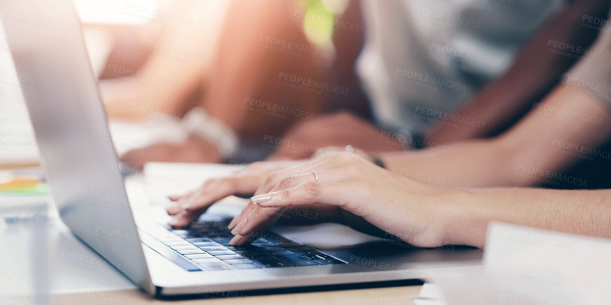 Buy stock photo Laptop, hands and typing at meeting in office with team, documents and planning at startup. Person, group and computer with project, proposal or review with paperwork in workplace at creative agency