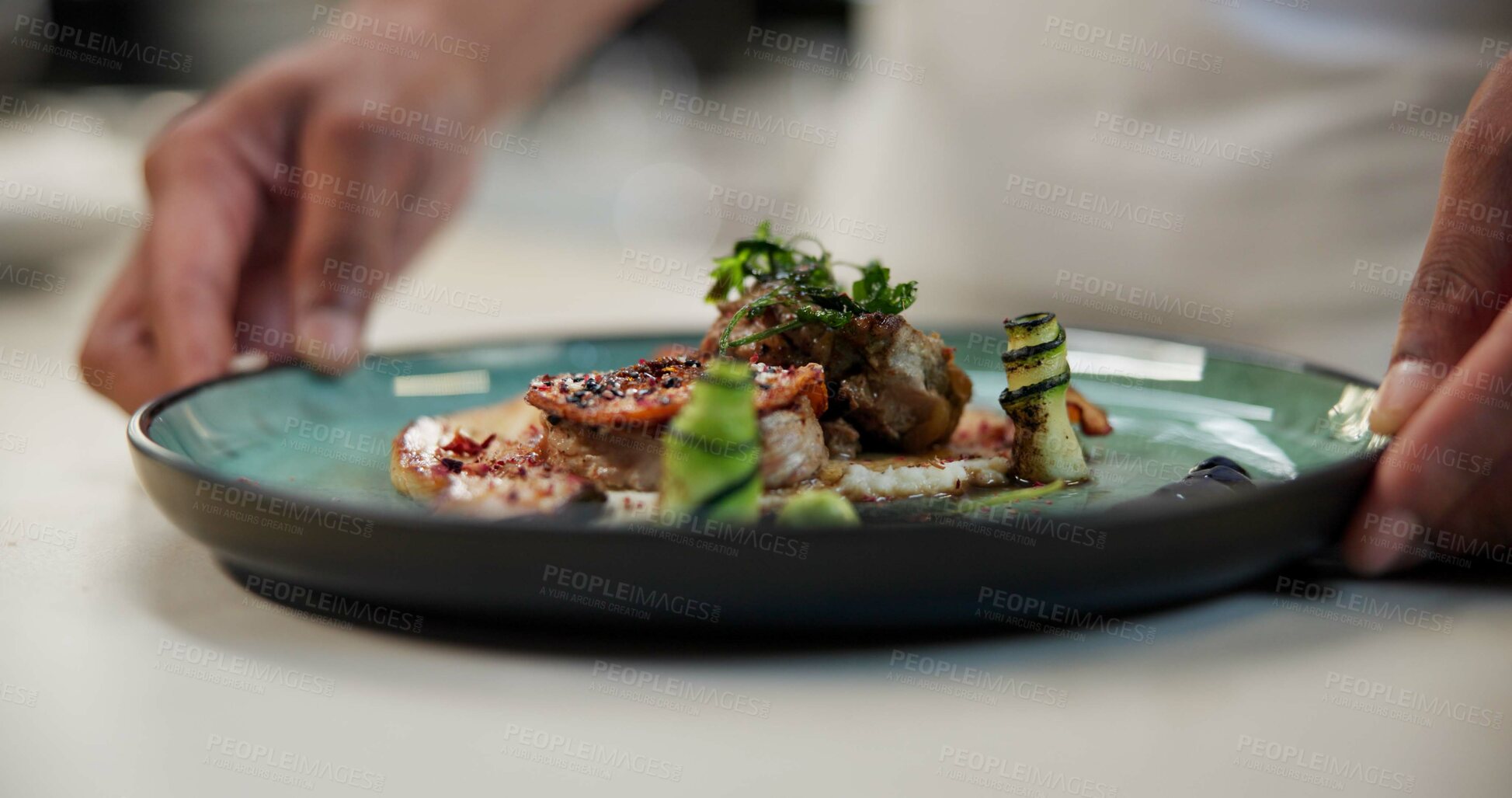 Buy stock photo Hands, food or person with ready dish in fine dining, culinary institute or luxury restaurant. Chef, healthy protein or fancy meal on plate for display, catering and hospitality in commercial kitchen