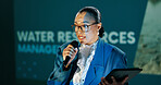 Conference, woman and workshop on stage for speech, talk or discussion for seminar host. Panel, mic and expert at speaker event for presentation on water management, sustainability or renewable forum