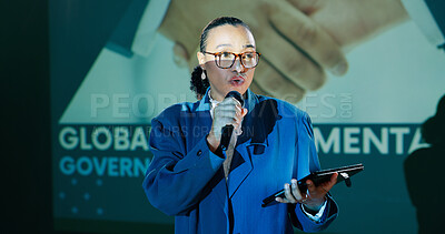 Woman, presentation and tablet at conference, stage and notes for global government policy. Person, touchscreen and microphone for speech, talk and public debate for compliance, law or human rights