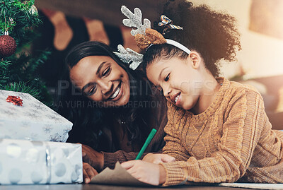 Buy stock photo Christmas, family and mother and girl writing letter to santa, relax and bond on living room floor. Love, child and mom help daughter with xmas wish list, happy and smile while enjoying conversation