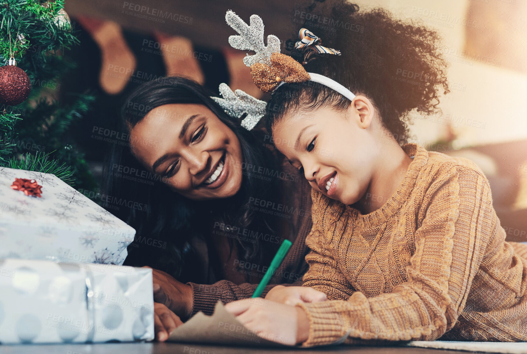 Buy stock photo Christmas, family and mother and girl writing letter to santa, relax and bond on living room floor. Love, child and mom help daughter with xmas wish list, happy and smile while enjoying conversation