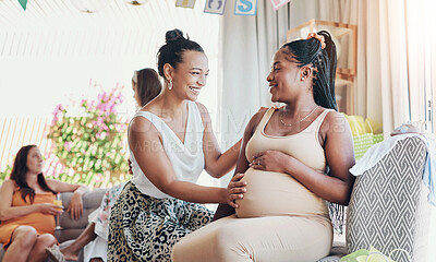 Buy stock photo Shot of a woman touching her friends belly during her baby shower