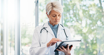 Buy stock photo Healthcare, mature doctor and typing on tablet for medical treatment, cure and reading online. Hospital and woman surgeon and digital for report review, solution and planning for diagnosis with tech