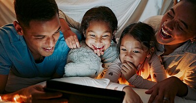 Buy stock photo Laughing, night and tablet with family in bedroom of home together for bonding, love or storytelling. Education, learning or funny with mom, dad and kids on bed in apartment for child development