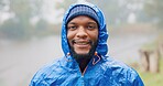 Black man, portrait and rain for travel outdoor on camping adventure, explore and nature journey in morning. African, male person and smile for hiking, freedom and trekking woods for winter vacation