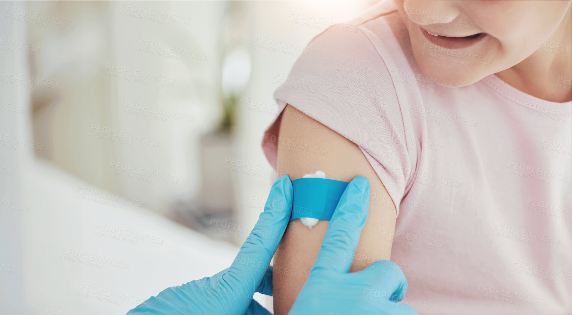 Buy stock photo Shot of an unrecognizable doctor applying a plaster to a little girl's arm after an injection at a hospital