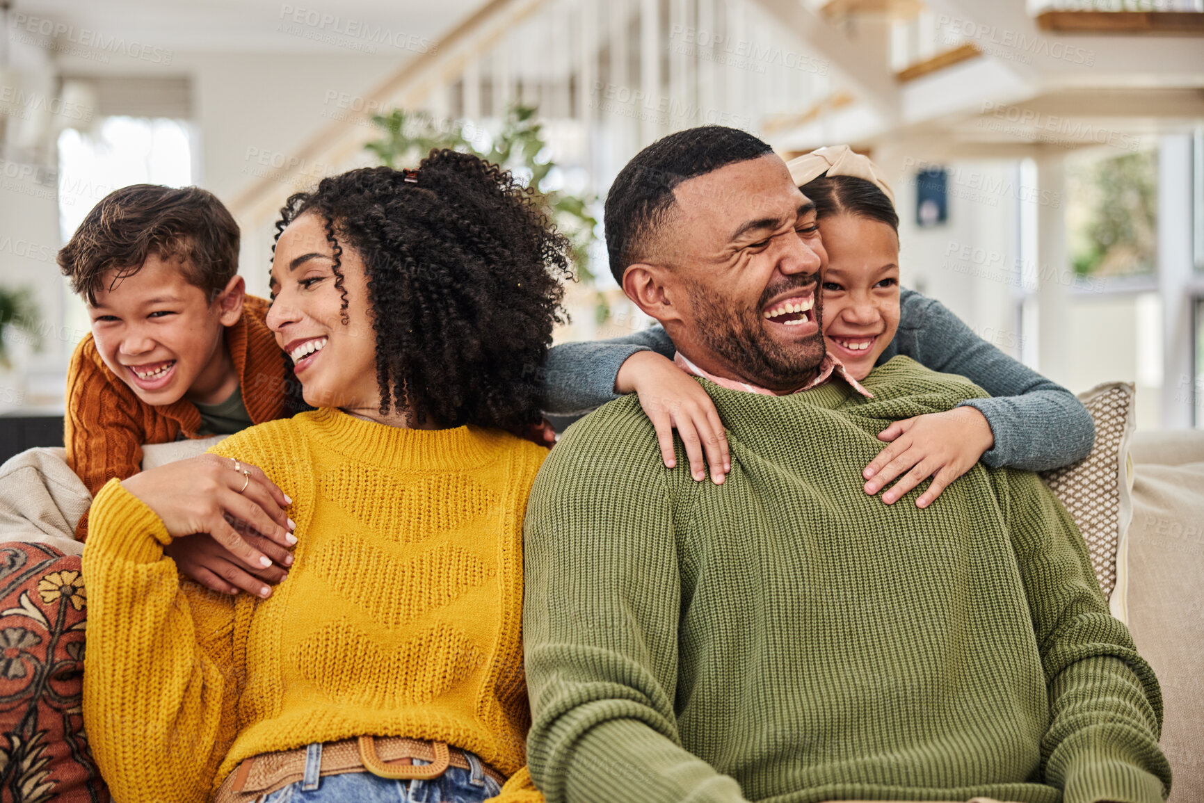 Buy stock photo Happy family, fun and excited on sofa for love, weekend fun and relationship development at home. Mother, father and kids on couch with growth, relax and hug for support or care in modern house