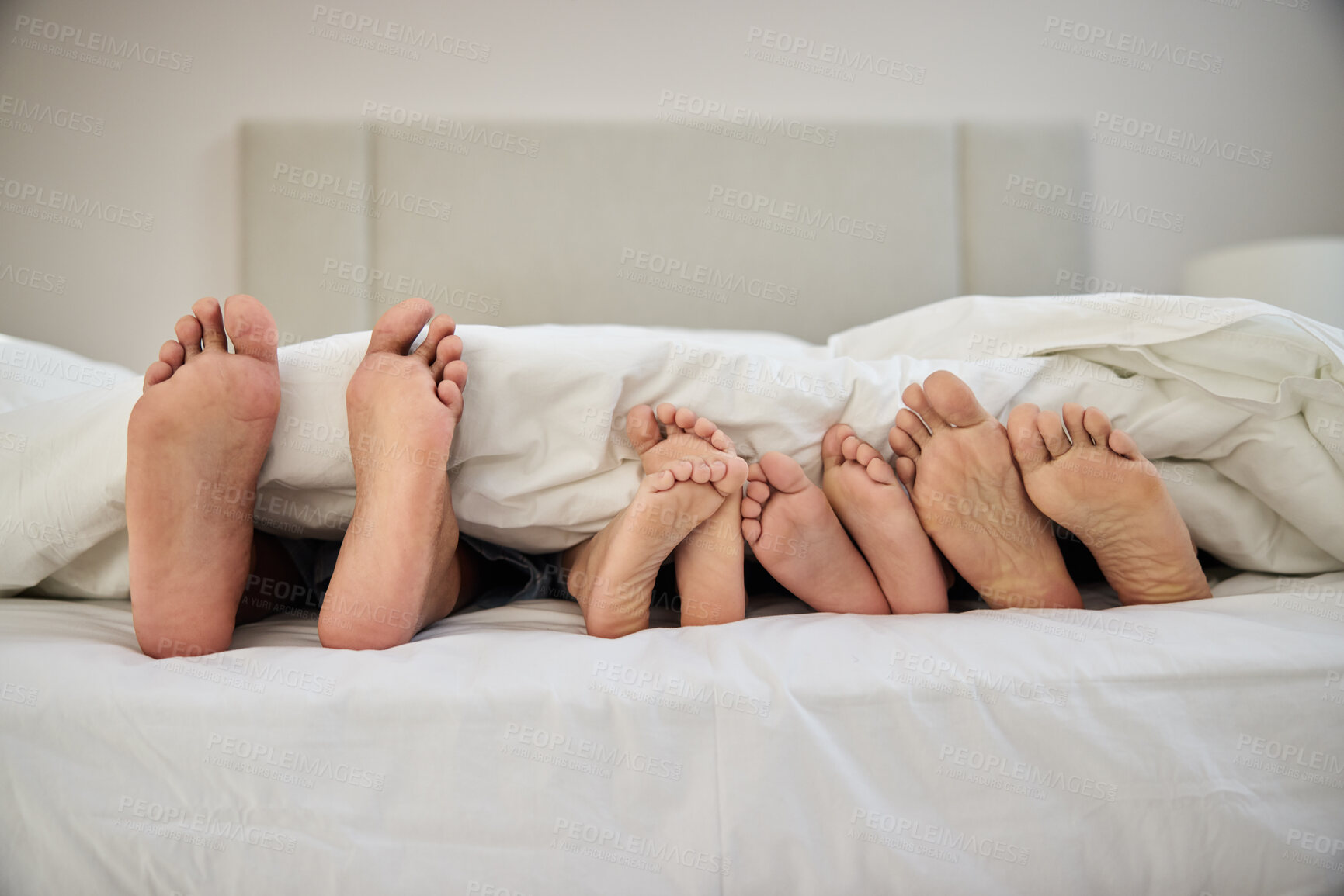 Buy stock photo People, relax and feet in home with blanket for peace, comfort and support in house as bonding. Foot, together and security in apartment bedroom for solidarity, sleeping and family health insurance