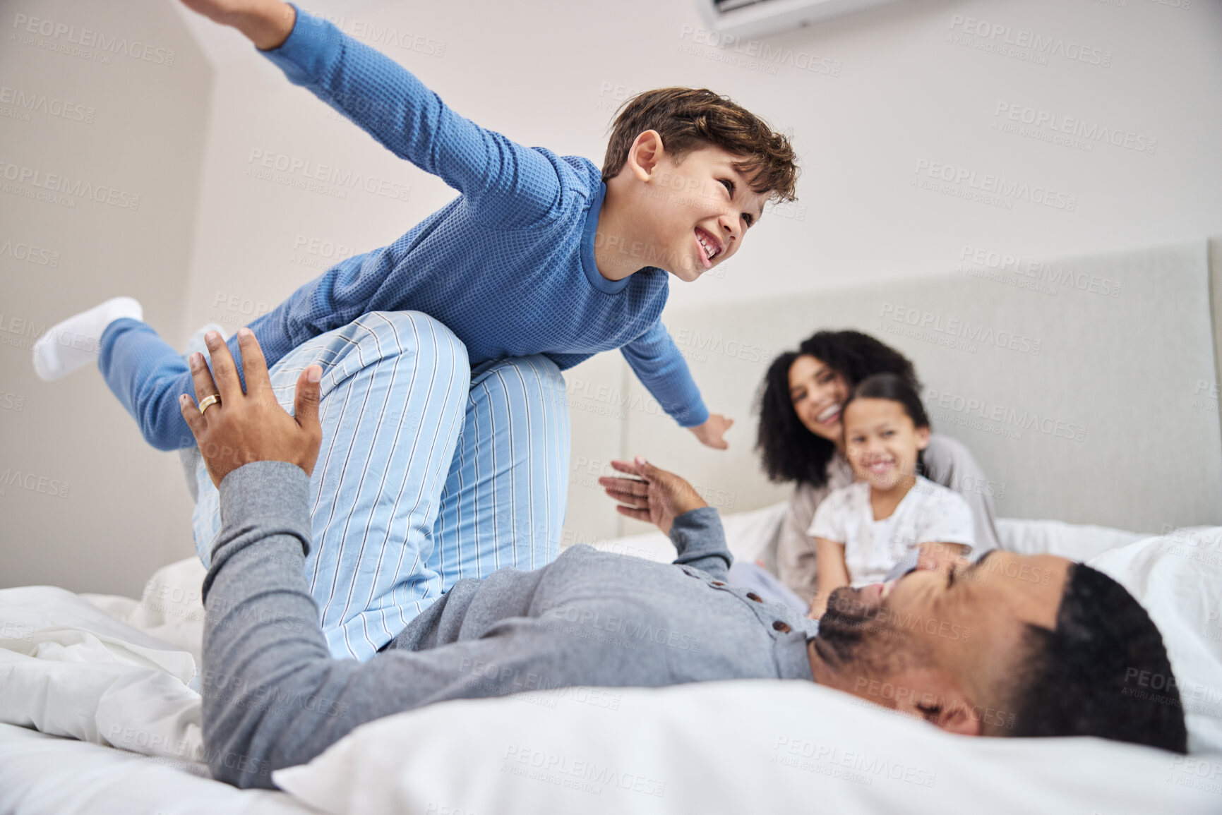 Buy stock photo Family, parents and children in bedroom, airplane and time together with happiness, relax and smile. Home, mother and father with kids, flying and cheerful with fun, playful and imagination with joy