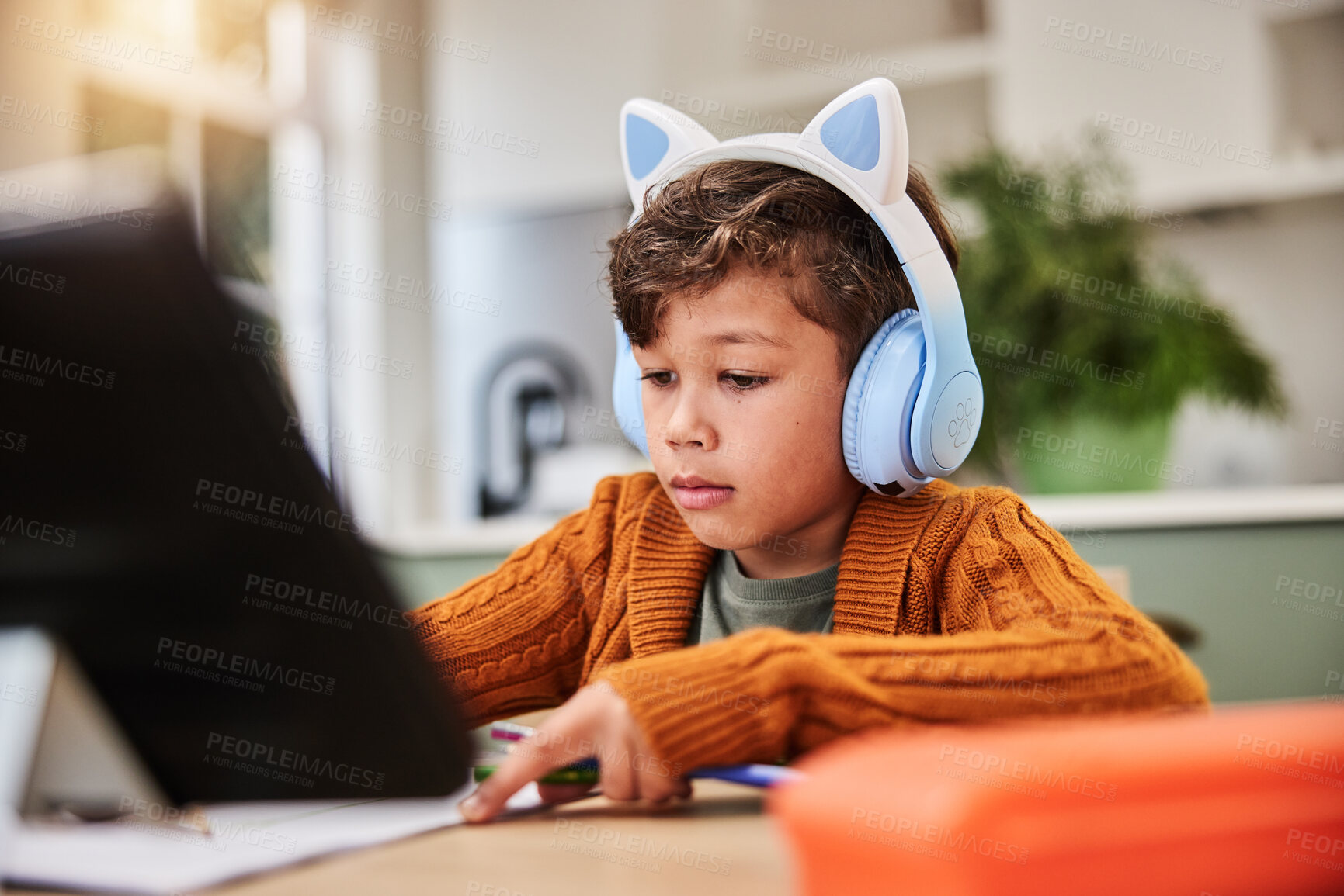 Buy stock photo Boy, headphones and tablet in home for elearning, virtual class and student writing in notebook or listening for lesson. Digital, homework and child development with connection, education and website