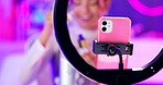 Phone, girl and ring light for live streaming with makeup or beauty tutorial for online followers in neon room. Influencer or content creator with phone for mascara, review or sponsorship at home