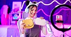 Home, influencer and girl live streaming with mobile, microphone or ring light for social media followers. Bedroom streamer with bag, fashion or product review for sponsorship in neon bedroom at home