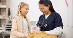 Woman, cat and child for checkup in clinic with conversation, assessment and medical exam for animal services. Girl, doctor and pet advice for discussion, healthcare and neutered for surgery feedback