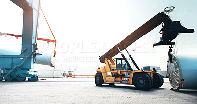 Buy stock photo A loader in a vehicle handling cargo in an industrial area. in industry a loader using vehicle to load shipment. Distribution products. Delivery, Logistics and Transportation