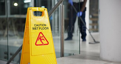 Buy stock photo Caution, sign and cleaning for floor, janitor and hygiene service and dark at night in office. Mop, job and disinfection with equipment with warning and male person, disinfectant and wet ground 