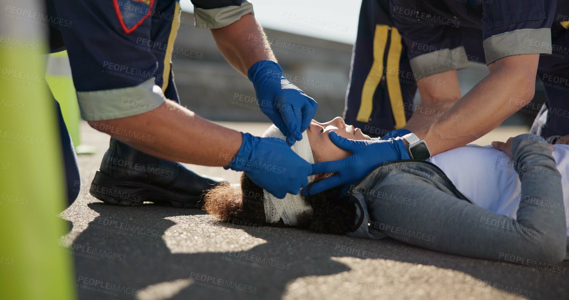 Buy stock photo Paramedic, emergency and hands on head injury on road in car crash accident with healthcare help. EMS, wrapping bandage and first responder with victim or rescue in street to save person outdoors