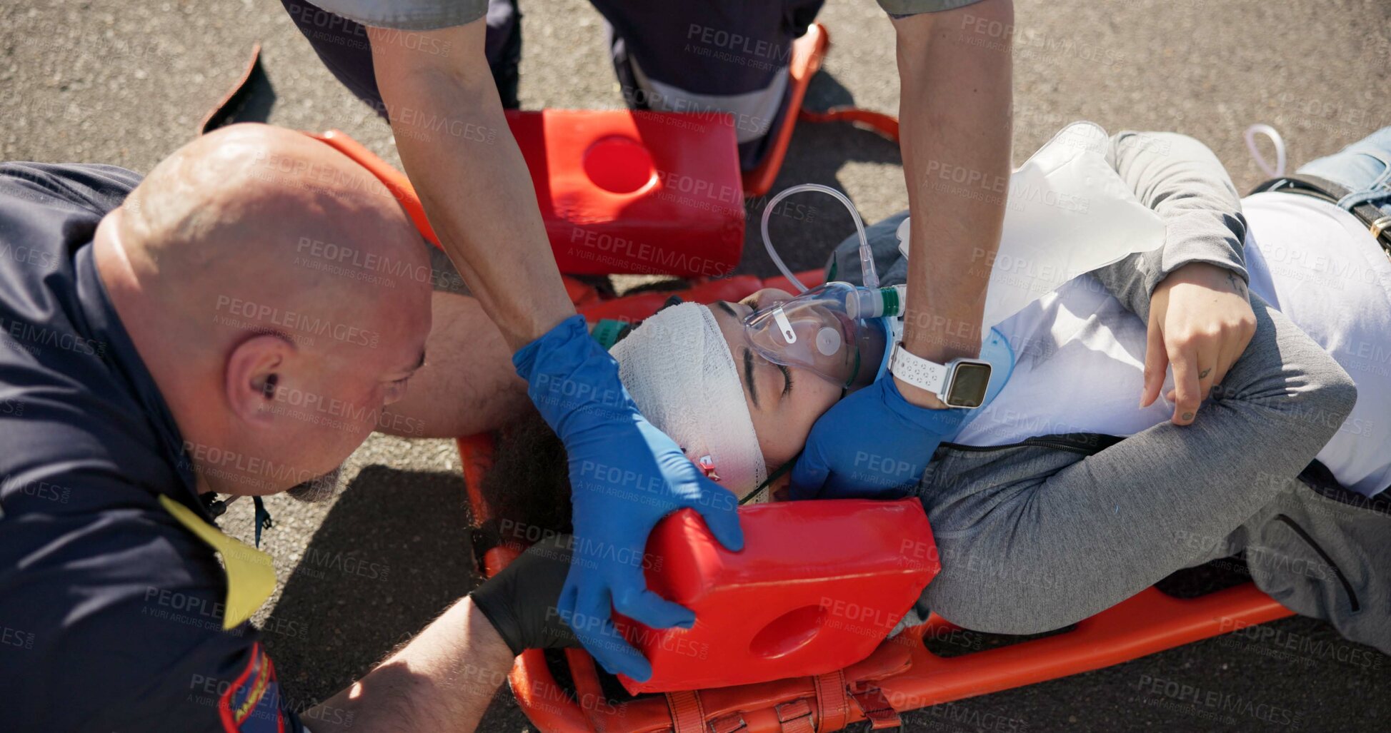 Buy stock photo Paramedic, emergency and road injury with traffic accident, healthcare and check of EMT men with first aid. Above, ambulance staff and medical help with rescue on stretcher for transport to clinic 