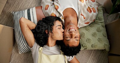 Buy stock photo Couple, above and kiss on cheek or new home floor, happiness and love for relationship or moving boxes. Relax, property investment and affection in apartment living room, people care and homeowners
