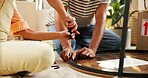 Hands, screwdriver and table with couple in living room of home for DIY, renovation or repairs. Building, moving in and tool with people on floor of apartment for construction of furniture together