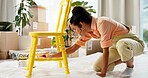 DIY, chair and yellow with painter woman in living room of apartment for creative renovation of furniture. Art, craft and painting with person in apartment for property or real estate maintenance