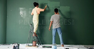 Buy stock photo Couple, people and house wall or painting, roller and home renovation or together in new apartment. Teamwork, property project and diy or make over for relationship, love and back view with care