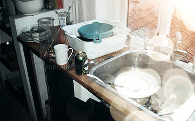 Buy stock photo Above messy and untidy kitchen sink with dirty dishes and empty beer bottles after a party. Start cleaning, glasses and cutlery in and around a sink in a filthy kitchen the morning after a fun night