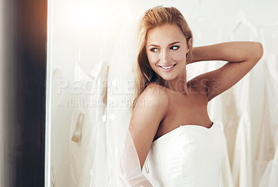 Buy stock photo A young bride trying on her wedding dress - Copyspace