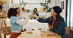 Girl, friends and happy fist bump in cafe for social meeting, connection and bonding at lunch date. Smile, brunch and women in coffee shop together for morning drinks, greeting and reunion at table